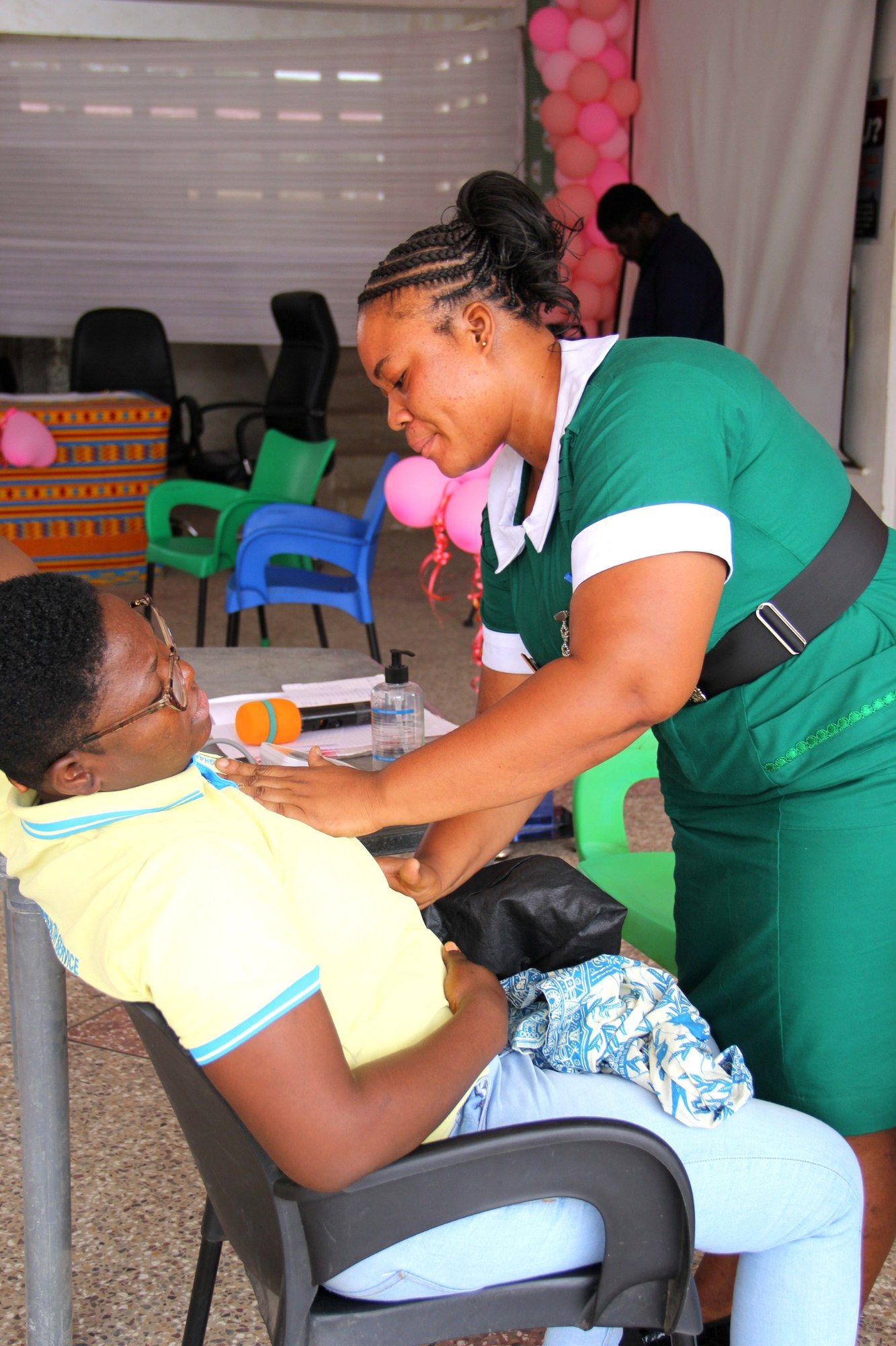 Nurse providing a breast health screening assessment to a participant